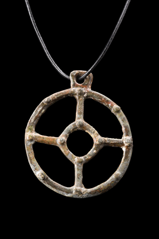 BRONZE AGE BRONZE SUN CROSS AMULET

 Ca. 600 BC
 Openwork bronze sun pendant ...