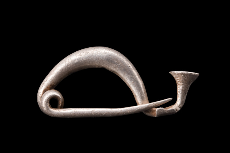 GREEK SILVER FIBULA

 Ca. 5th-4th century BC
 A silver fibula with a coiled p...