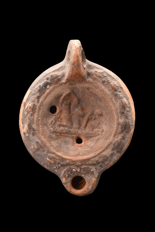 ROMAN TERRACOTTA OIL LAMP WITH AN EROTIC SCENE 

 Ca. 1-100 AD
 A Loeschcke V...