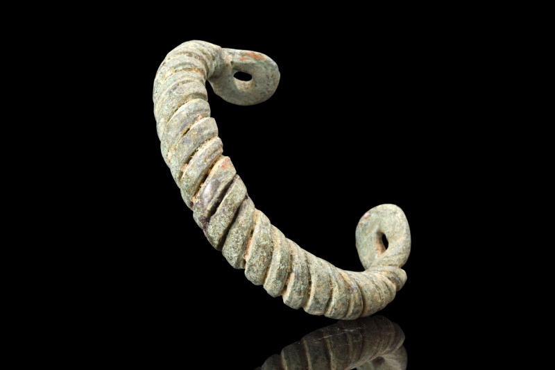 VIKING ERA BRONZE TWISTED BRACELET

 Ca. 900-1100 AD
 A penannular bronze bra...