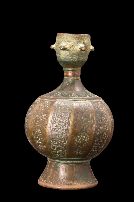 ABBASID BRONZE PERFUME BOTTLE

 Ca. 9th century AD
 A bronze bottle features ...