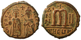 Phocas, with Leontia, 602-610. Follis (bronze, 10.47 g, 27 mm), Theoupolis (Antioch). O N FOCA NЄ PЄ AV Phocas standing facing, holding globus crucige...