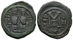 Justin II and Sophia, AD 565-578. AE, Follis. 13.76 g. 31.37 mm. Nicomedia.
Obv: DNIVSTI-NVSPPA[VC]. Justin II on left and Sophia on right, seated, ni...