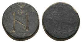 AE One-nomisma Weight. Eastern Mediterranean/Aegean. AD 6th/7th centuries.
Discoid in form with plain profile; engraved on the top with the denominati...