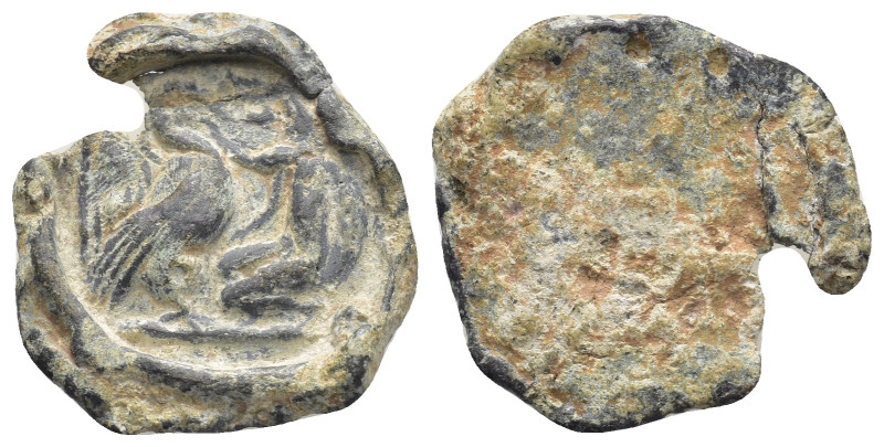 Lead Seal (20mm, 4.68 gr) Obv: Winged figure kneeling, feeding eagle?. Rev: Blan...