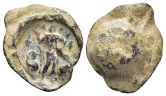Lead Seal (22mm, 8.5 gr) Obv: Male figure standing facing. Raising right hand. Rev: Blank