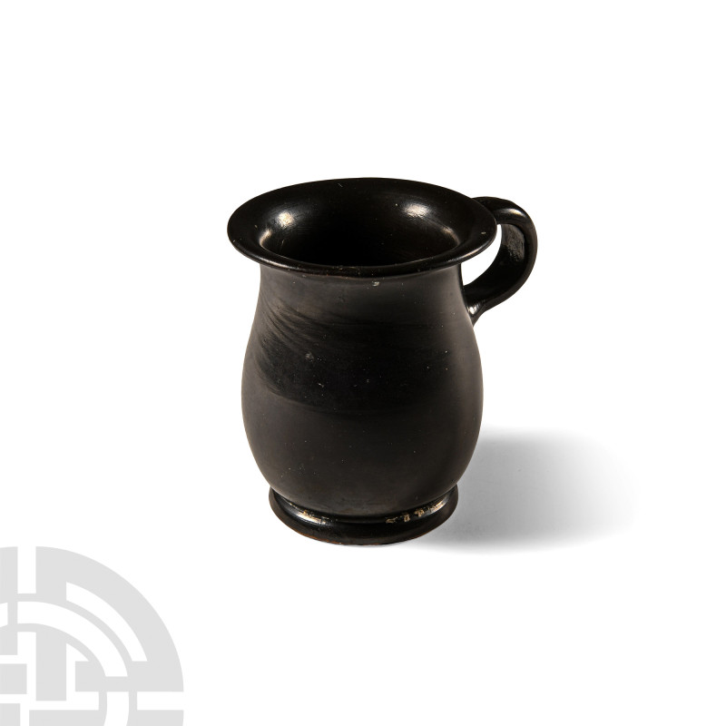 Greek High-Glazed Black Ware Mug
4th-3rd century B.C. With flared base, bulbous...