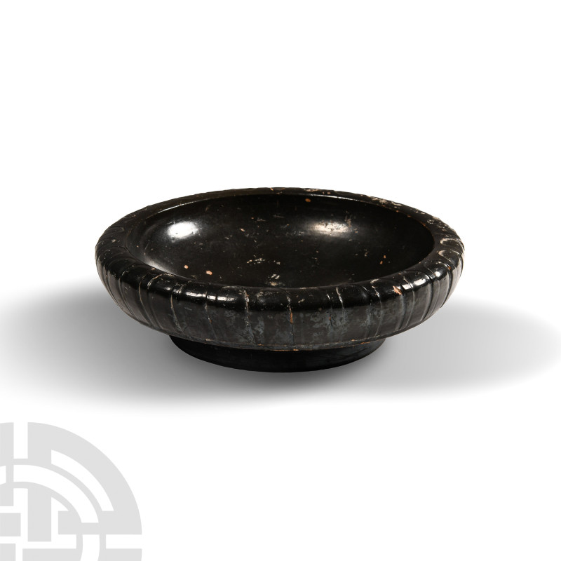 Greek Black-Glazed Plate
5th-4th century B.C. Shallow-bodied with broad foot; i...