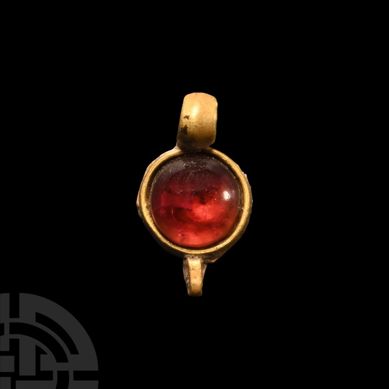 Roman Gold and Garnet Pendant
1st-4th century A.D. The gold circular setting in...