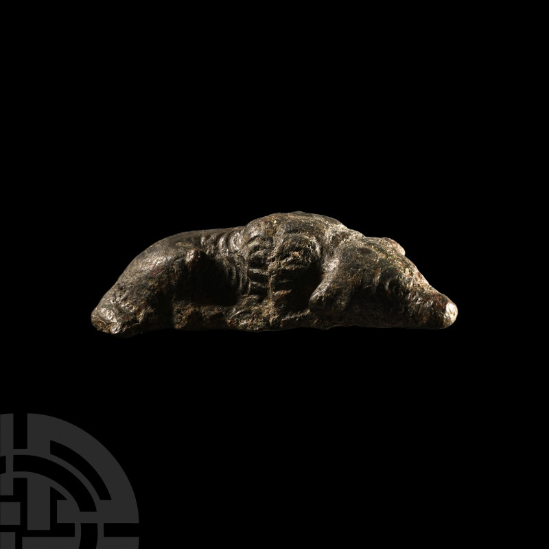 Roman Bronze Lying Dog Statuette
1st-4th century A.D. Modelled in the round wit...