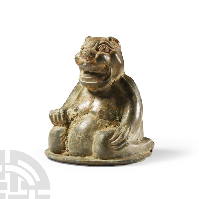 Chinese Han Style Bronze Animal
20th century A.D. Shown seated, resting on its ...