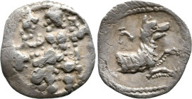 Greek
LYCAONIA. Laranda. (Circa 324/3 BC)
AR Obol (11.6mm 0.56g).
Obv: Baaltars seated left, holding grain ear and grape bunch in his right hand an...