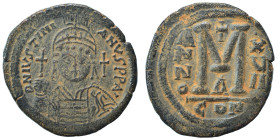Justinian I, 527-565. Follis (bronze, 21.12 g, 35 mm), Constantinople. Helmeted and cuirassed bust facing, holding globus cruciger. Rev. Large M; A/N/...