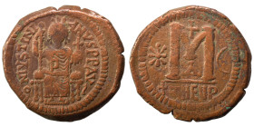 Justinian I, 527-565. Follis (bronze, 18.45 g, 34 mm), Theoupolis (Antioch). Justinian seated facing on throne, holding scepter and globus cruciger. R...
