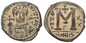 Justinian I, 527-565. Follis (bronze, 19.79 g, 36 mm), Theoupolis (Antioch). Helmeted and cuirassed bust facing, holding globus cruciger and shield; c...