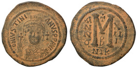 Justinian I, 527-565. Follis (bronze, 21.99 g, 42 mm), Nicomedia. Helmeted and cuirassed bust facing, holding globus cruciger, shield on left shoulder...