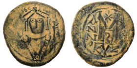 Maurice Tiberius, 582-602. Follis (bronze, 12.10 g, 32 mm), Cyzicus. Helmeted and cuirassed bust facing, holding globus cruciger and shield decorated ...
