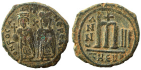 Phocas, with Leontia, 602-610. Follis (bronze, 10.99 g, 27 mm), Theoupolis (Antioch). O N FOCA NЄ PЄ AV Phocas standing facing, holding globus crucige...