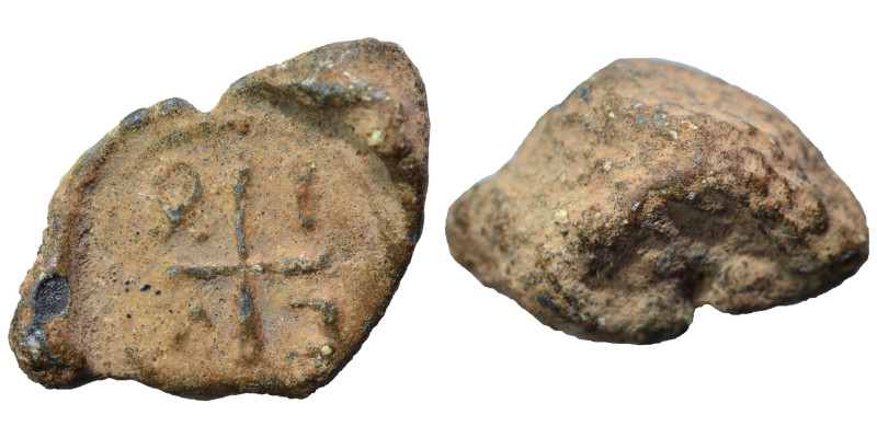Byzantine seal (lead, 6.74 g, 20 mm). Cross with letter in each angle. Rev. Blan...