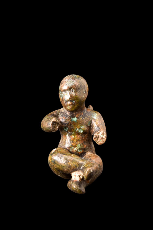 ROMAN BRONZE SEATED CUPID FIGURINE 

 Ca. 100-200 AD
 A bronze figurine portr...