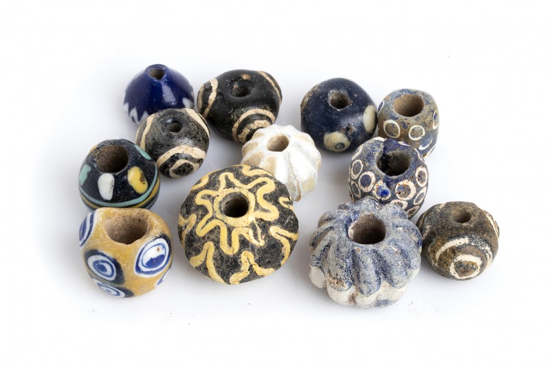 Group of twelve Egyptian polychrome glass Beads
4th century BC - 1st century AD...