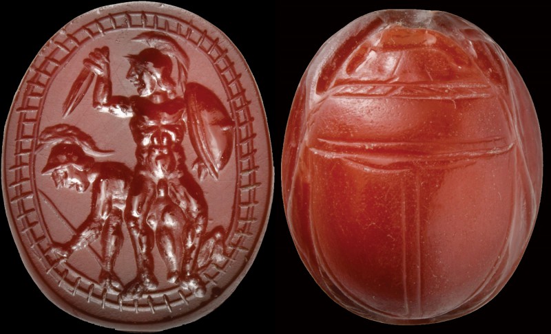 A precious etruscan scarab in deep red carnelian. Two warriors. In the foregroun...