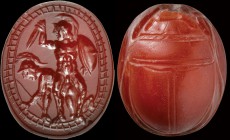 A precious etruscan scarab in deep red carnelian. Two warriors. In the foreground there is the winning warrior, protected by a shield, ready for a mor...