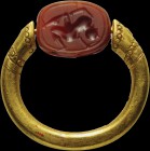 An intaglio on an etruscan carnelian scarab, mounted on an ancient gold ring. Man running to the right. Globular elements. Wear marks. For comparisons...