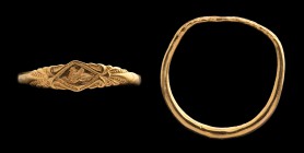 A greek gold ring. Sphynx. On the bezel, of a romboidal shape, there is a sphynx, stretched forward, within a chiselled frame. At each of the two endi...