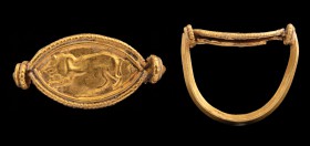 An etruscan gold ring. Lion. Bezel in the shape of an almonds (also said "eye shape"), embossed with the figure of a lion, turned to the left; the bor...