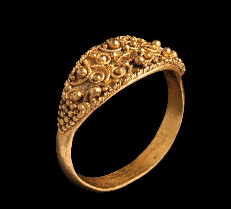 An etruscan gold ring. 4th century B.C. Ogival bezel, almond shape, surrounded b...