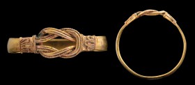 A greek gold ring. Hercules' knot. The ring is characterized by a flat and thin hoop, ending by an elegant Hercules' knot; the latter is done with a r...