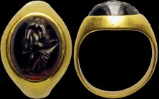 A hellenistic garnet intaglio, mounted on an ancient gold ring. Danae. The figure is turned to the right, with the body in three quarters and the head...