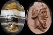 An italic banded agate intaglio. Bearded head of a man, wearing a laurel wreath, and in profile to the left. Wear marks and light chipping on the bord...