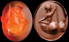A roman carnelian intaglio. Sea scene. A male character (triton?), turned to the left, is holding a stick (or wheel?), surfacing from the sea in a big...
