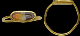A roman banded agate intaglio, mounted on an ancient gold ring. Crostacean. Elegant combination, made of a flat and elongated bezel, of an excellent g...