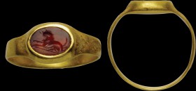 A roman carnelian intaglio, mounted on a gold ring. Quadruped. The feline is characterized by several projecting udders, a long tail and a hirsute man...
