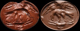 A roman red jasper intaglio. An eagle with its prey. The bird of prey, its wings spread, is ripping a mammal (presumably a hare) while still flying. A...