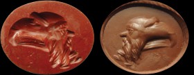A roman red jasper intaglio. The hybrid being is made of two heads, one of Silenus and one of eagle. Apotropaical intaglio, characterized by deep carv...