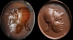A roman sard intaglio. An actor with a mask. The juvenile face, turned to the left, has on his head (still partially worn over his face) the mask of a...