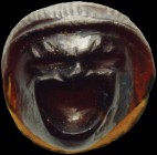 A roman garnet cameo. Comical theater mask, with the mouth wide open, made in high relief with a flat base (as a bezel for the mounting on the piece o...