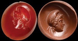 A roman deep red carnelian intaglio. Head of Ganymede. The young face, in profile to the left, is framed by thick hair, partially covered by a phrygia...