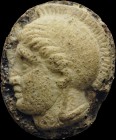 A roman glass-paste cameo. Helmeted head of Athena, turned to the left. The figure, characterized by a round chin, full mouth and big eyes, is inspire...