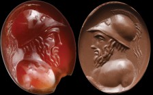 A deep red carnelian intaglio. Bust of a warrior. The character, turned to the right, is wearing a greek helmet, and shows a long beard and powerful m...