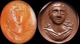 A roman carnelian agate intaglio. Female bust, wearing a tunic. The young woman is turned three quarters, with semi-closed lips and hair flowing over ...