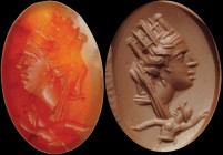 A roman carnelian intaglio. Veiled bust of a city (personification), wearing turreted crown; at the bottom, protome of a swimming man, which can be id...