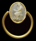 A roman agate - chalcedony cameo, mounted on an ancient gold ring. Reading girl. The female figure, elegantly draped, is turned to the left, and seate...
