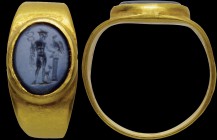 A roman nicolo intaglio, mounted in an ancient gold ring. Mercury with attributes. The god, standing up and turned to the right, is wearing the winged...