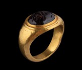 A hellenistic garnet intaglio, mounted on an ancient gold ring. A butterfly and a centipede. Globular elements. The stone shows an ancient fracture, t...