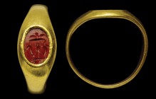 A roman red jasper intaglio, mounted in an ancient ring. Trapeza . On the elegant, three-legged table (presumably zoomorphic legs), there are a small ...